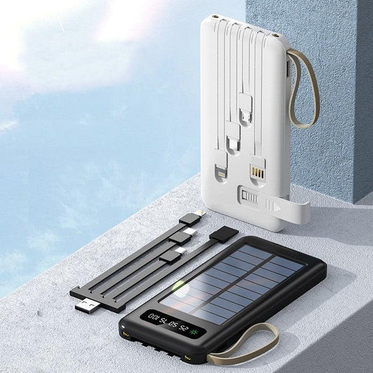White and black portable solar power banks with multiple charging cables and LED display on gray surface