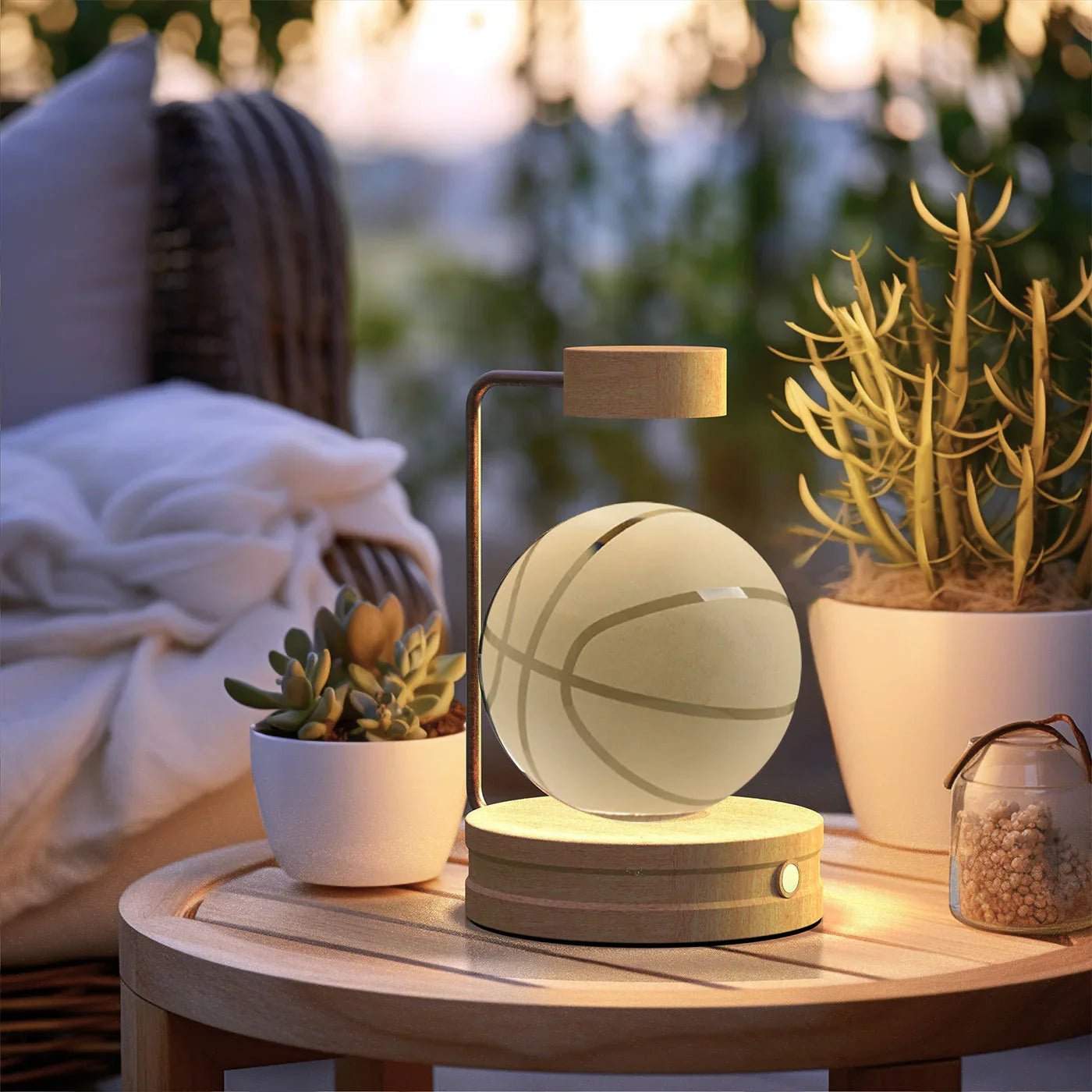 wooden levitating basketball lamp on round wooden table with potted succulents in cozy outdoor setting