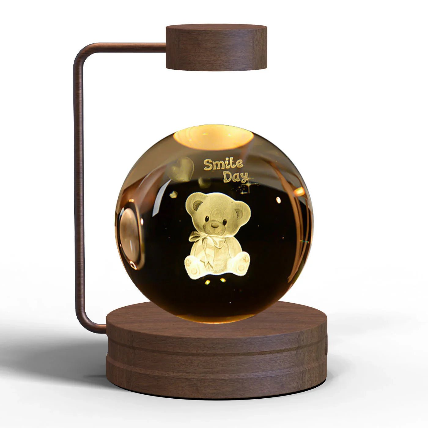 wooden levitating lamp with floating glass sphere featuring a teddy bear and Smile Day text