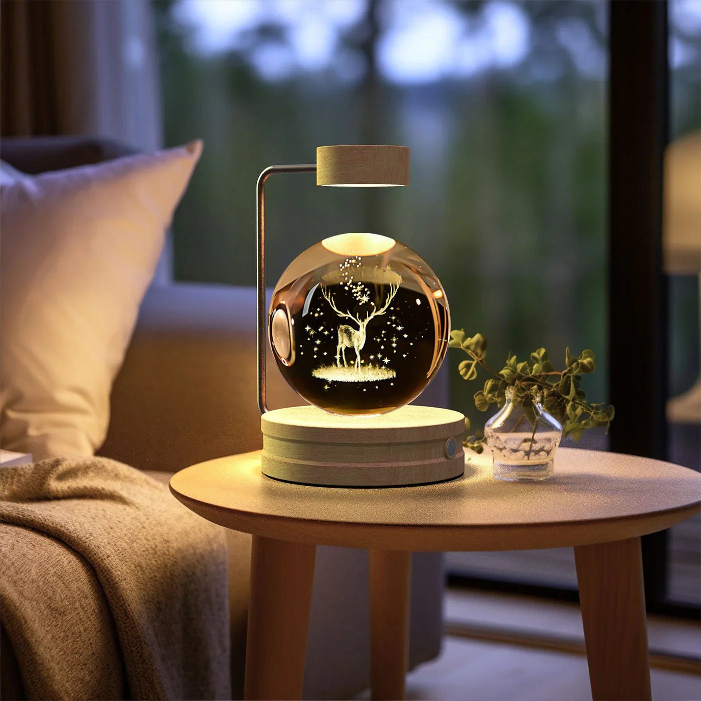 Decorative crystal globe lamp with illuminated deer design on wooden side table in cozy living room