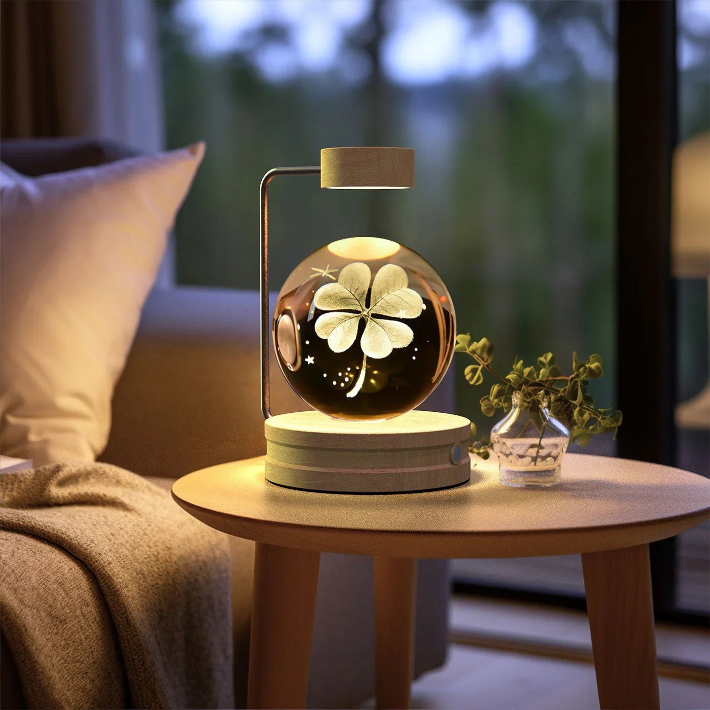 Levitating glass orb lamp with four-leaf clover design on wooden side table in cozy living room