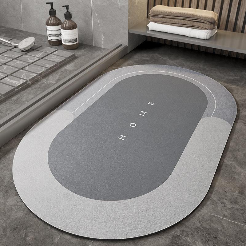 Modern gray and white home bath mat on marble bathroom floor with towels and soap dispensers