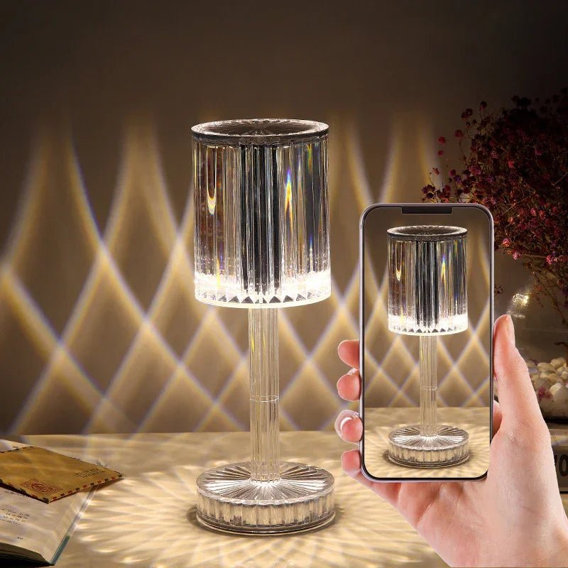 Hand holding smartphone capturing crystal table lamp with decorative light patterns on wall