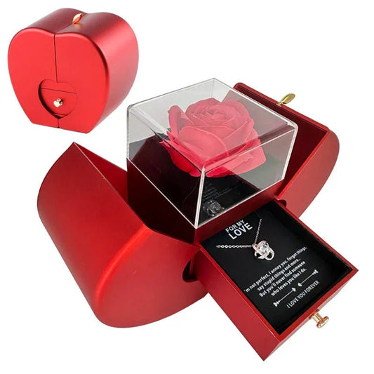 Heart-shaped red jewelry box with a preserved red rose under a clear cover and a silver necklace with a love message
