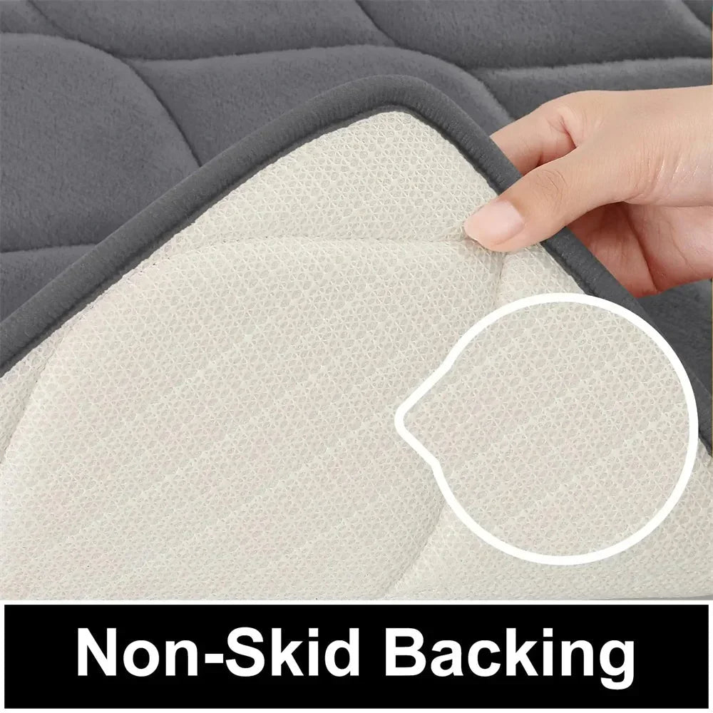 Hand lifting corner of dark gray cushion showing white non-skid backing with close-up texture