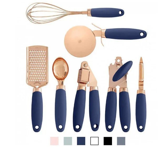 Set of rose gold and navy blue kitchen utensils including whisk, grater, pizza cutter, garlic press, can opener, and peeler