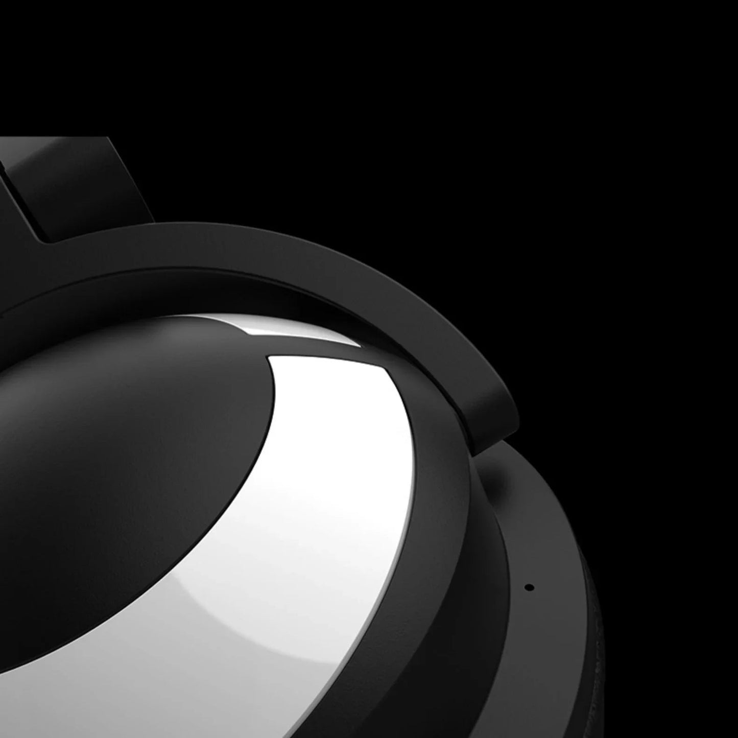 Close-up of black and silver over-ear headphones with sleek modern design on black background