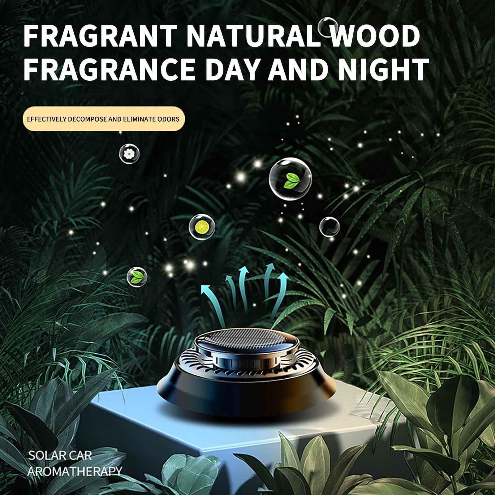 Black solar car aromatherapy diffuser releasing natural wood fragrance in lush green leaves