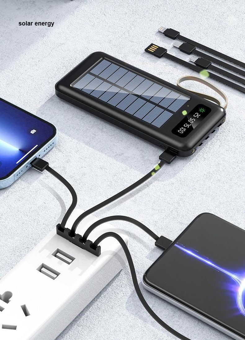 Black solar power bank with digital display charging two smartphones and multiple USB cables on white surface